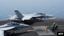 F/A-18E fighter jets on the flight deck of the USS George H.W. Bush aircraft carrier in this recent U.S. Navy handout photo obtained Aug. 8, 2014.