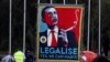FILE - Marijuana activists use a sign to call on President Barack Obama to make the drug legal, Nov. 16, 2011.