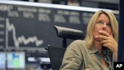 A stock broker works at the Frankfurt stock exchange, Germany, August 19, 2011