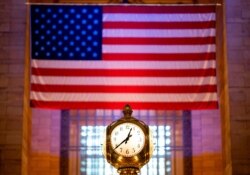 Grand Central clock is pictured in front of the American flag amid the coronavirus pandemic in Grand Central train station April 24, 2020, in New York City.