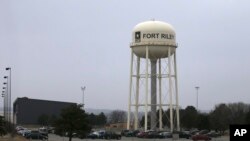 FILE - Vehicles park around a water tower at Fort Riley, Kansas, Feb. 9 2015. According to a criminal complaint filed Monday, a U.S. Army soldier has been arrested after sharing bomb-making instructions online.