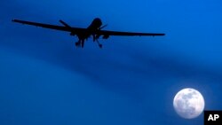FILE - An unmanned U.S. Predator drone flies on a moonlit night, Jan. 31, 2010.