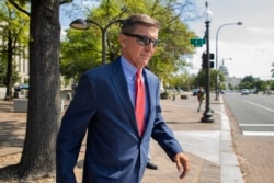FILE - Michael Flynn, President Donald Trump's former national security adviser, leaves federal court in Washington, Sept. 10, 2019.
