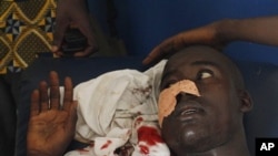A man who says he was shot in the face by security forces loyal to Laurent Gbagbo while walking home in the Abobo neighborhood waits to receive stitches at a health clinic in the Anyama suburb of Abidjan, Ivory Coast, March 12, 2011