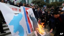South Korean protesters burn a portrait of North Korean leader Kim Jong Un during a rally against a visit of North Korean Hyon Song Wol, head of North Korea's art troupe, in front of Seoul Railway Station in Seoul, Jan. 22, 2018.