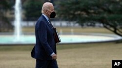 President Joe Biden walks from Marine One towards the Oval Office on the South Lawn of the White House in Washington, Jan. 11, 2023. 