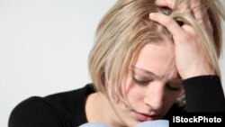 FILE - A woman suffers from depression.