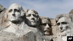 FILE - This March 22, 2019, file photo shows Mount Rushmore in Keystone, S.D. President Donald Trump will begin his Independence Day weekend on Friday with a patriotic display of fireworks at Mount Rushmore National Memorial before a crowd of…