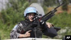 UN forces patrol outside the UN headquarters in Ivory Coast, Abidjan, Ivory Coast, Tuesday, Dec. 21, 2010.