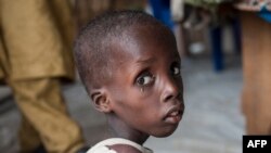 FILE - A boy suffering from severe acute malnutrition sits at one of the UNICEF nutrition clinics in the Muna settlement, which houses nearly 16,000 internally displaced people in the outskirts of Maiduguri, capital of Borno state, Nigeria, June 30, 2016.