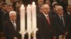 Palestinian President Mahmoud Abbas, left, attends a Christmas Midnight Mass at the Church of the Nativity in the West Bank town of Bethlehem, early Friday, Dec. 25, 2015.