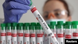 A test tube labelled "Mpox virus positive" is held in this illustration taken August 20, 2024. 