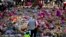 A man stands next to flowers for the victims of Monday's bombing at St Ann's Square in central Manchester, England, May 26 2017.