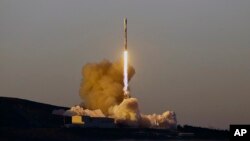 FILE - A Falcon 9 rocket lifts off from Vandenberg Air Force Base, Calif., March 30, 2018. On Friday, a SpaceX rocket launched 10 more voice and data satellites for Iridium Communications, which is replacing its entire fleet with a new generation of orbiters. 