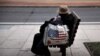 Michael Doss sits outside his tent in a Washington, DC, park. Doss has been homeless for more than a year. (Chris Simkins/VOA)