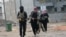 Gunmen patrol during clashes with Iraqi security forces in Fallujah, 40 miles (65 kilometers) west of Baghdad, Iraq, Jan. 5, 2014. 