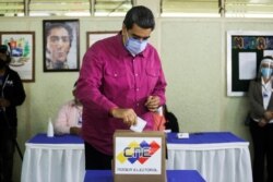 FILE - Venezuela's President Nicolas Maduro votes at a polling station during the parliamentary election in Caracas, Venezuela, Dec. 6, 2020.
