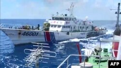FILE - Screen grab shows Chinese Coast Guard ship 46001 (L) chasing a Vietnamese vessel near the site of a Chinese oil rig in disputed waters in the South China Sea, off Vietnam's central coast. 