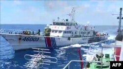 FILE - This screen grab from a June 1, 2014 video shows a Chinese Coast Guard ship 46001 chasing a Vietnamese vessel near to the site of the Chinese oil rig in the disputed waters in the South China Sea, off Vietnam's central coast. 