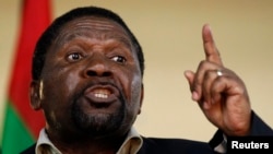 FILE - Isaias Samakuva, leader of Angola's main opposition UNITA party, addresses supporters at a rally in Viana, east of Luanda, Aug. 29, 2012. 