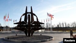 A man stands outside NATO headquarters in Brussels, Belgium, Jan. 6, 2020. 