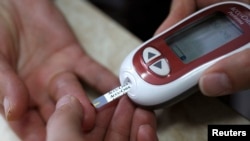 A patient takes a blood glucose test during an event aimed to help people with diabetes to cope with their illness at Saint Luka diagnostics medical center in Sofia, November 13, 2012. Picture taken November 13, 2012. REUTERS/Stoyan Nenov (BULGARIA - 