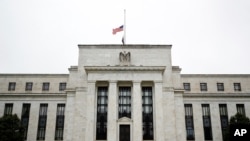 The Federal Reserve building is viewed in Washington, May 22, 2020. Federal Reserve officials last month expressed concerns about the severity of the economic downturn triggered by the coronavirus pandemic.