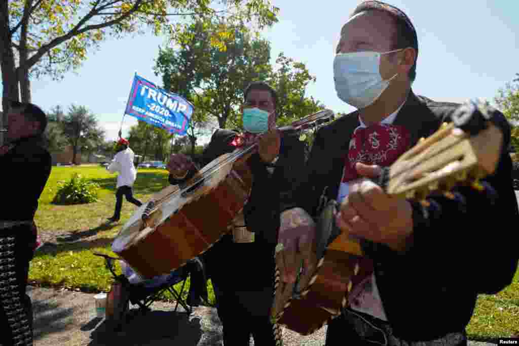 A Mariachi band play outside of a polling site on Election Day in Houston, Texas, Nov. 3, 2020. 