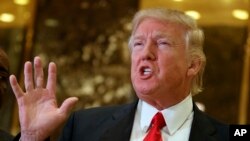 FILE - President-elect Donald Trump speaks with reporters in the lobby of Trump Tower in New York, Jan. 13, 2017. Trump has called the U.S.-Korea Trade Agreement a "horrible" trade deal.