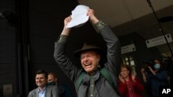 Milieudefensie Director Donald Pols, holding a copy of the verdict, celebrates the outcome in the court case of Milieudefensie, the Dutch arm of the Friends of the Earth environmental organization, against Shell in The Hague, Netherlands.