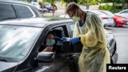 រូបឯកសារ៖ ពលរដ្ឋ​ម្នាក់​ត្រូវ​បាន​ធ្វើតេស្ត​នៅក្នុង​រថយន្ត នៅក្នុង​អំឡុង​ពេល​មាន​ការផ្ទុះឡើង​នៃ​ជំងឺ កូវីដ​១៩ នៅ​ទីក្រុង Austin រដ្ឋ Texas សហរដ្ឋ​អាមេរិក​នៅ​ថ្ងៃទី ២៨ ខែមិថុនា ឆ្នាំ ២០២០។ REUTERS/Sergio Flores