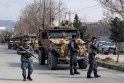 Foreign security personnel and Afghan police arrive at the site of an attack in Kabul, Afghanistan, March 6, 2020.