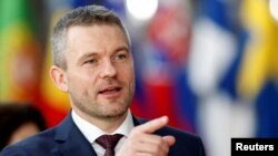 FILE - New Slovak Prime Minister Peter Pellegrini gestures as he arrives at a European Union summit in Brussels, Belgium, March 22, 2018. 
