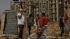 In this Sunday, Nov. 17, 2013 photo, Egyptian municipality laborers work on a memorial base two days before the commemoration of deadly clashes with security forces in 2011, in Tahrir Square, Cairo.