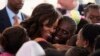 U.S.first lady Michelle Obama hugs students at Martin Luther King middle school, an all-girls school in Dakar, Senegal, June 27 2013. 
