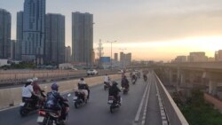 FILE - Vietnam is the fourth biggest market in the world for motorbikes, which millions of drivers like these in Ho Chi Minh City rely on daily.