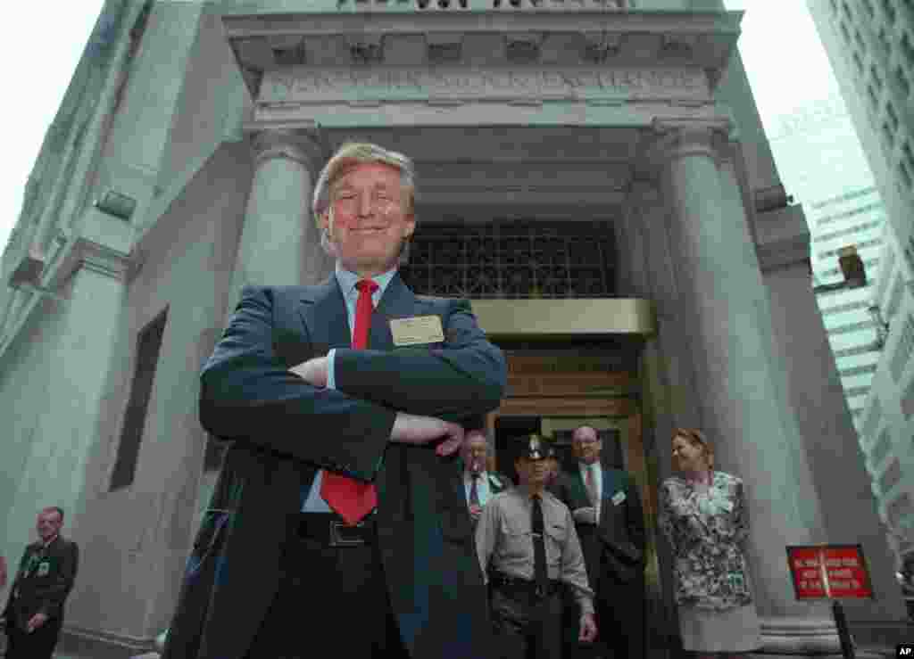 Developer Donald Trump poses for photos outside the New York Stock Exchange after the listing of his stock on Wed., June 7, 1995 in New York. He took his flagship Trump Plaza Casino public, offering 10 million shares of common stock at an estimated price