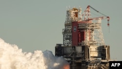 This NASA handout photo shows the core stage for the first flight of NASA’s Space Launch System rocket during a scheduled fire test, Jan. 16, 2021, at NASA’s Stennis Space Center near Bay St. Louis, Miss.