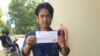 Chhoun Chheng shows his registration slip after authority in Pailin province allowed him to register there. Chheng was refused twice before at two other provinces. 