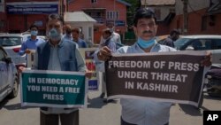 Kashmiri journalists hold placards during a protest against a new media policy that was announced last month in Srinagar, Indian controlled Kashmir, July 6, 2020.