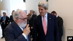 European Union Climate Commissioner Miguel Arias Canete (L) welcomes US Secretary of State John Kerry for talks to reduce hydrofluorocarbons under the Montreal Protocol at Vienna International Center in Vienna, Austria, July 22, 2016.