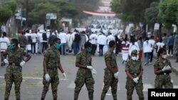 Oromia Special Force members wait to check attendees during Irreecha celebrations, the thanksgiving festival of the Oromo people, in Bishoftu town, Oromia region, Ethiopia, Oct. 4, 2020.
