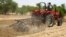 A farmer plows the field in Saulawa village, on the outskirts of Nigeria's north-central state of Kaduna, May 2013 file photo. 
