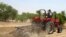 A farmer plows the field in Saulawa village, on the outskirts of Nigeria's north-central state of Kaduna, May 2013 file photo. 