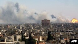 A handout image released by the Syrian opposition's Shaam News Network on August 1, 2013, shows flames billowing from the site of an ammunitions depot blast in the Wadi al-Zahab district of Homs in central Syria.