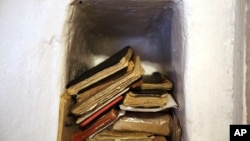 Handbooks of prayers and hymns, known as 'cuadernos', sit in a niche in the adobe wall of the morada de San Isidro, outside Holman, New Mexico, April 15, 2023.