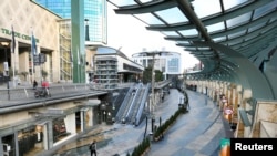 People walk an empty shopping street as Netherlands is set to extend the lockdown as the spread of the coronavirus continues in Rotterdam, Netherlands, Jan. 12 2021.