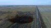FILE - This aerial photo shows a spill from TransCanada Corp.'s Keystone pipeline, Nov. 17, 2017, near Amherst, S.D. The spill, originally estimated at 210,000 gallons of oil, is now deemed to have been about 407,000 gallons.