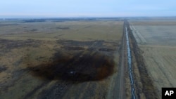 FILE - This aerial photo shows a spill from TransCanada Corp.'s Keystone pipeline, Nov. 17, 2017, near Amherst, S.D. The spill, originally estimated at 210,000 gallons of oil, is now deemed to have been about 407,000 gallons.