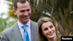 FILE - Spain's Crown Prince Felipe and Princess Letizia smile as they attend the inauguration of the "Palmetum" botanic park in Santa Cruz de Tenerife, on the Spanish Canary Island of Tenerife, Jan. 28, 2014. 